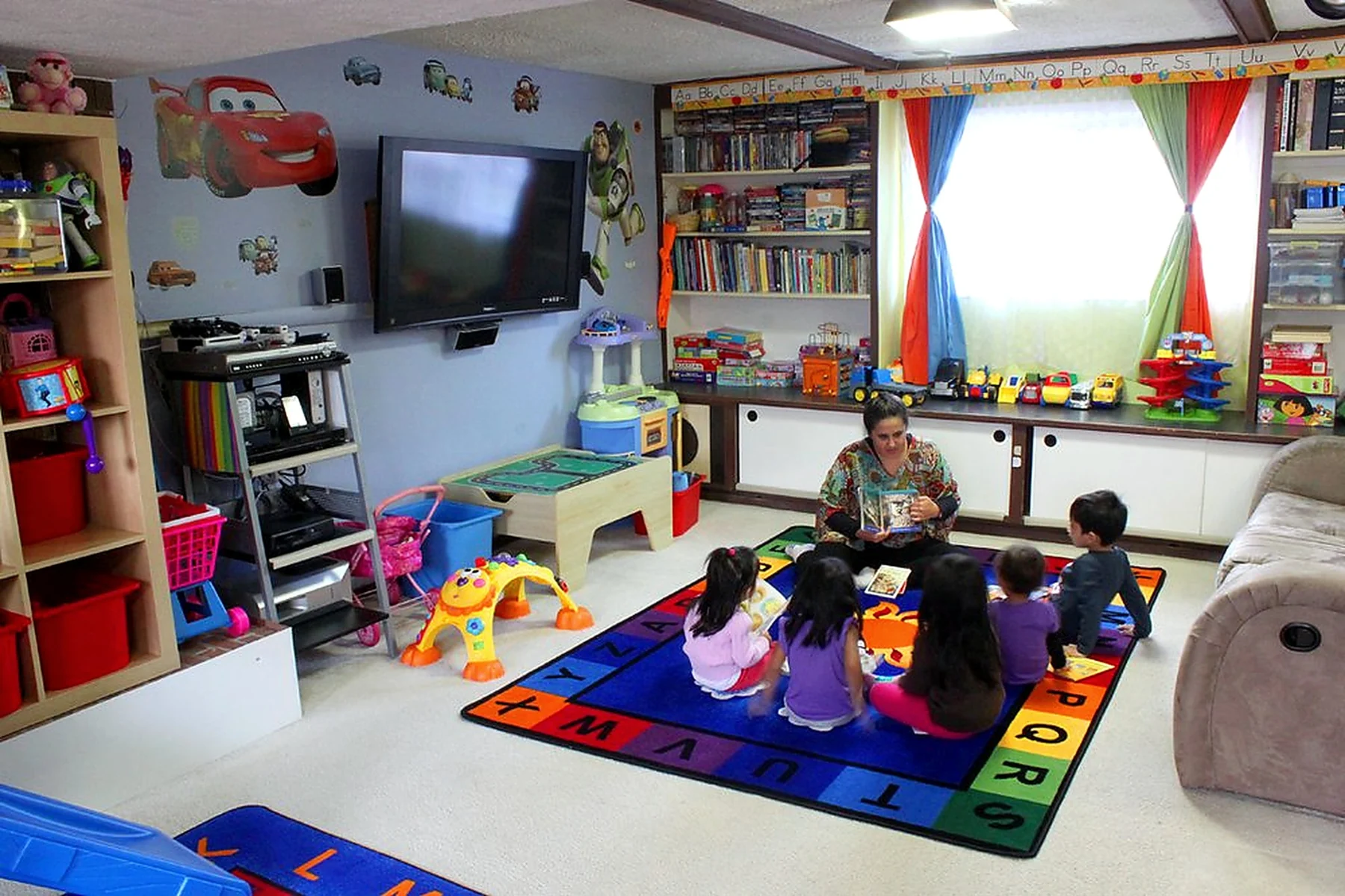 Teacher reading with children at Patricia's Daycare